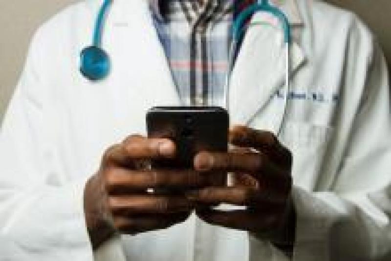 Doctor reviewing data on smart phone